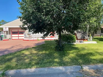 Exterior view of a single-story building with a yard.