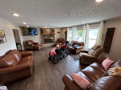Comfortable common area with residents in wheelchairs