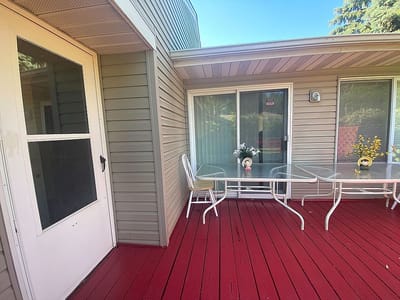 Outdoor patio area with chairs and flowers