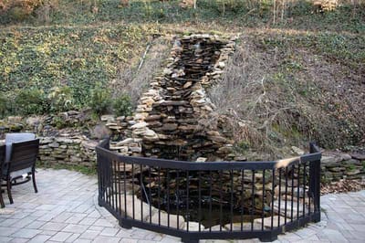 Outdoor waterfall feature in a garden area.