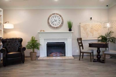 Cozy common area with a fireplace and seating.