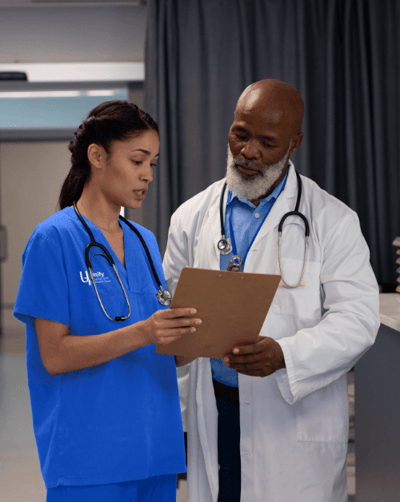 Two healthcare professionals discussing patient care.