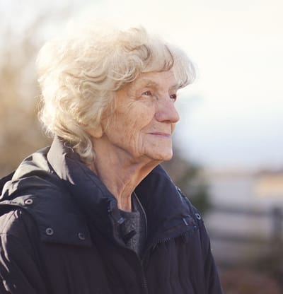 Elderly woman smiling outdoors