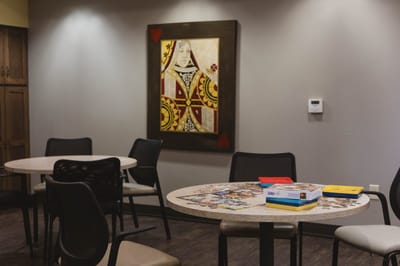 Common area with art and puzzle table.