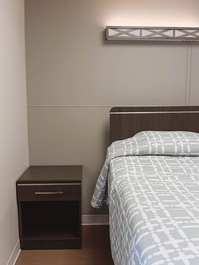 Cozy bedroom interior with nightstand.