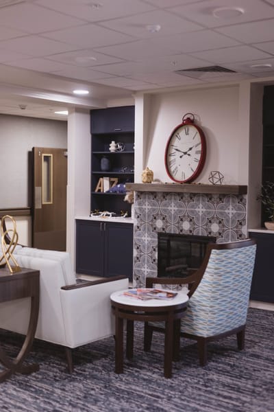 Cozy common area with seating and a fireplace.