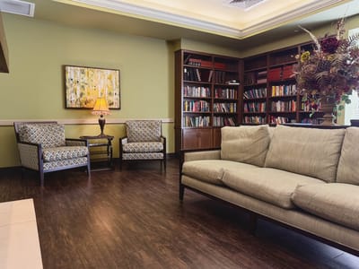 Cozy lounge area with bookshelves and seating.