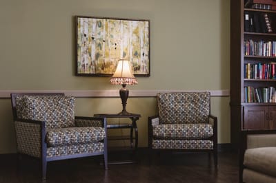 Cozy common area with armchairs and lamp