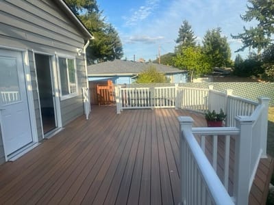 Spacious deck area with railing and greenery