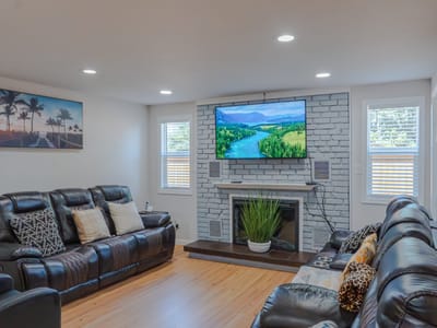 Cozy common area with leather couches and a TV.