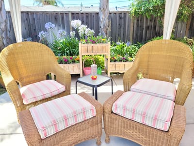 Cozy outdoor seating area with flowers.
