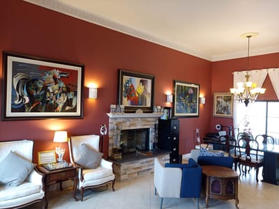 Warm interior lounge with artwork and furniture.