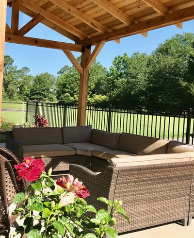 Outdoor seating area with flowers and greenery
