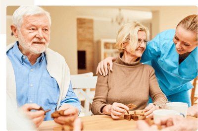 Residents engaging in a social activity with staff.