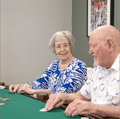 Two seniors playing cards together