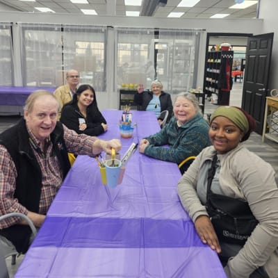 Residents and staff engaged in an arts activity together.