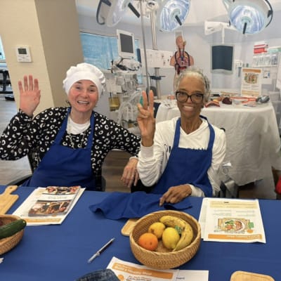 Residents participating in a cooking activity with fruits.