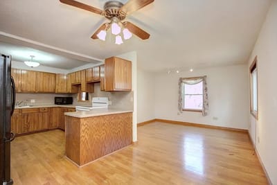 Bright kitchen area with wooden cabinets and window