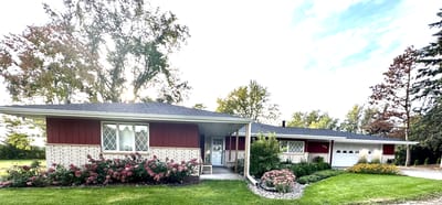 Exterior view of a red and white assisted living facility