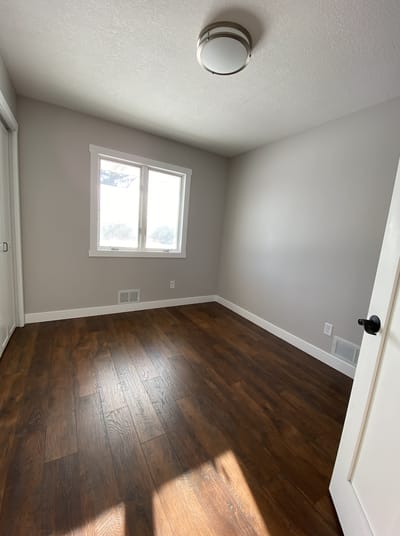 Empty private room with wood floor and natural light