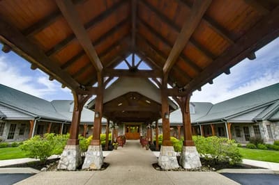 Entranceway of a senior living facility with wooden architecture