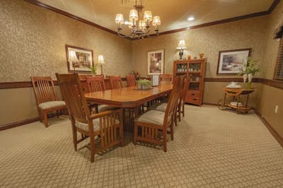 A spacious dining room with a large wooden table