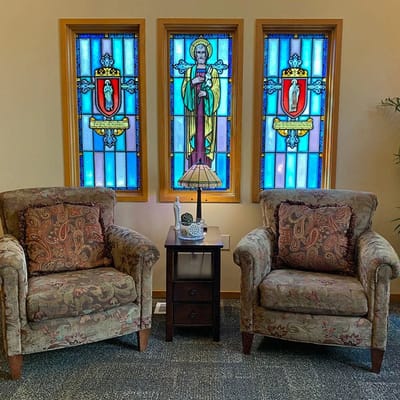 A cozy sitting area with stained glass windows