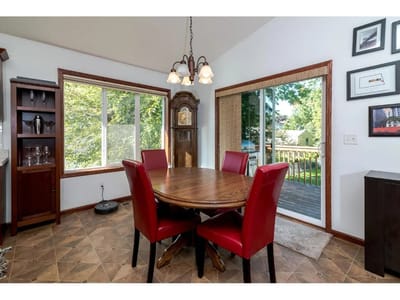Cozy dining area with a round table and red chairs