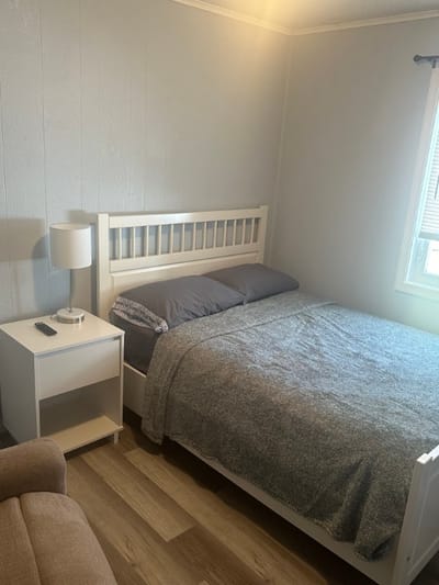 Cozy private room with a bed and lamp