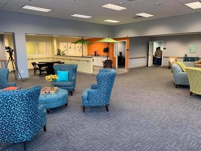 Bright common area with seating and residents
