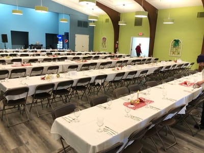 Dining area set up for an event with tables and chairs