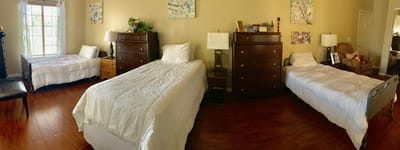 Interior view of a resident room with beds and furniture