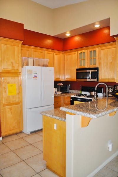 Bright kitchen area with wooden cabinets and appliances