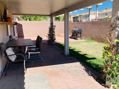 Outdoor patio area with seating and grill