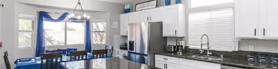Bright, modern kitchen space with seating and appliances