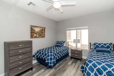 A bright, comfortable resident bedroom with twin beds