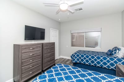 A cozy resident room with two beds and dressers