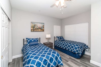 Two twin beds in a well-lit room with artwork