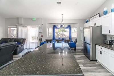 Bright kitchen area with blue accents and seating