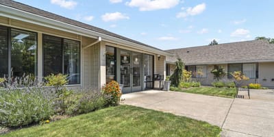 Exterior view of a senior living facility with gardens