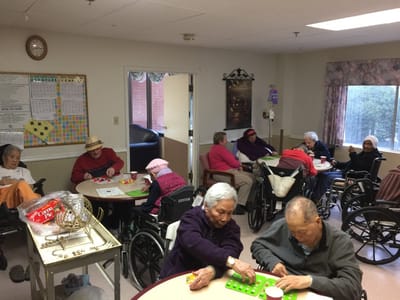 Residents engaged in a bingo game in a common area