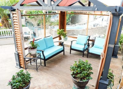 Outdoor seating area with blue cushions and potted plants