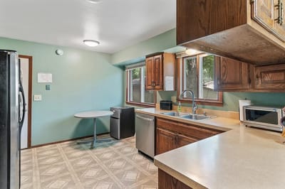 A kitchen area with countertop and appliances