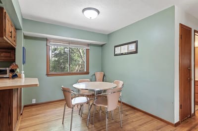 Brightly lit interior room with a table and chairs