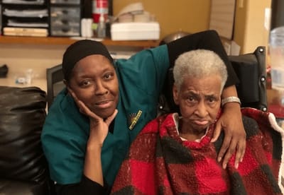 Caregiver and resident sharing a moment in an indoor setting