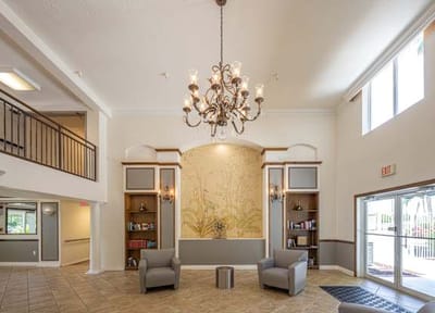Lobby area with chandelier and bookshelves