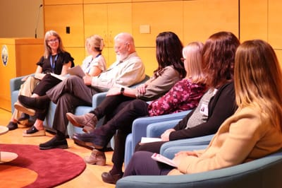 Residents and staff engaged in a discussion