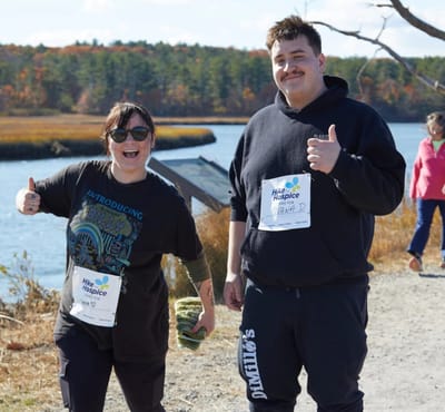 Two participants enjoying an outdoor activity by the water.