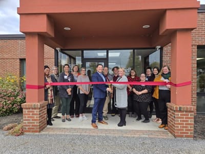 Ribbon cutting event with staff and guests.