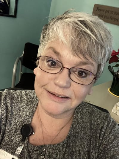 Staff member smiling in a common area